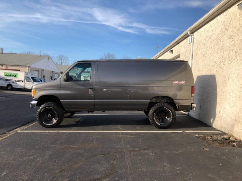 Gray 117K 1997 Ford E250 Quigley 4×4 For Sale | GuysWithRides.com